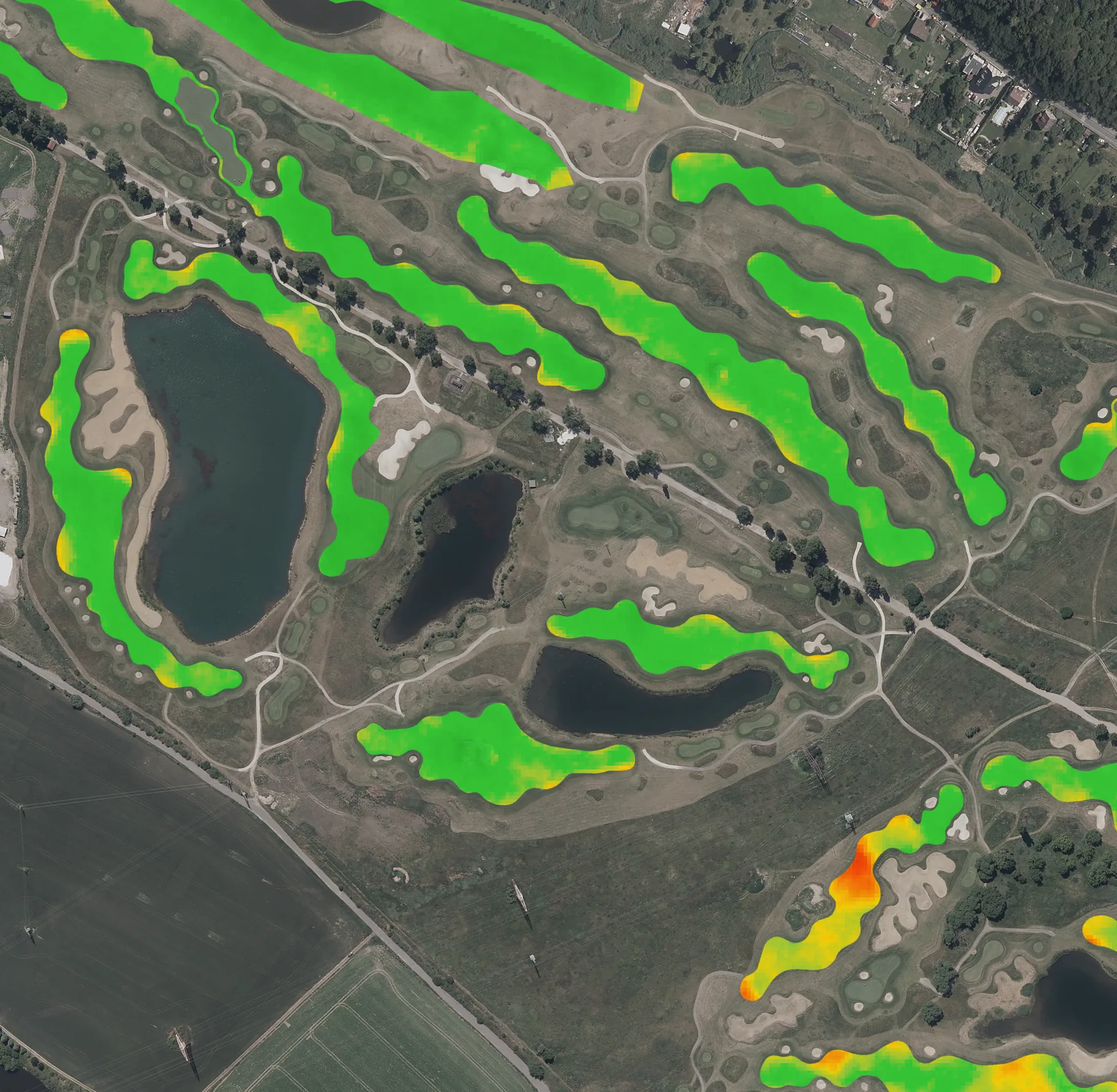 Aerial photo of a golf course with every fairway coloured by difference from its normal: mostly green, a few holes orange and red